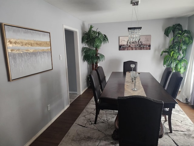 18534 Wolf Creek Trl, Humble, TX 77346 - dining space featuring wood finished floors, a chandelier, and baseboards