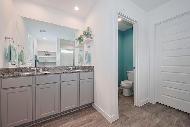 31707 Whittis Hill Way, Fulshear, TX 77441 - bathroom with a shower stall, wood finished floors, toilet, double vanity, and baseboards