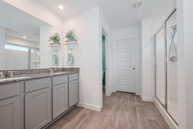 31707 Whittis Hill Way, Fulshear, TX 77441 - full bath featuring a stall shower, wood finished floors, double vanity, and baseboards