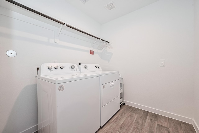 31707 Whittis Hill Way, Fulshear, TX 77441 - laundry room with washer and clothes dryer, light wood-style flooring, and baseboards