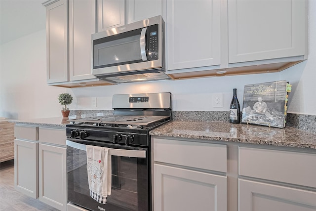 31707 Whittis Hill Way, Fulshear, TX 77441 - kitchen with appliances with stainless steel finishes, light wood finished floors, and light stone counters