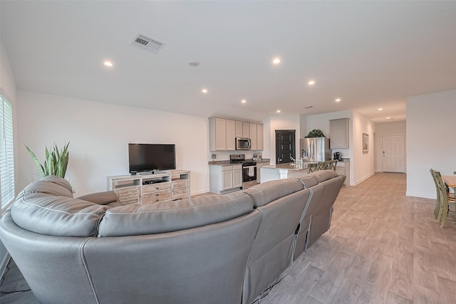 31707 Whittis Hill Way, Fulshear, TX 77441 - living area featuring light wood-type flooring, recessed lighting, and baseboards