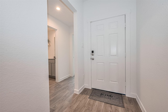 31707 Whittis Hill Way, Fulshear, TX 77441 - doorway to outside featuring wood finished floors, baseboards, and recessed lighting
