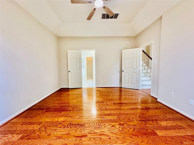 4142 Surreydon Dr, Houston, TX 77014 - unfurnished bedroom featuring wood finished floors, baseboards, a towering ceiling, and ceiling fan
