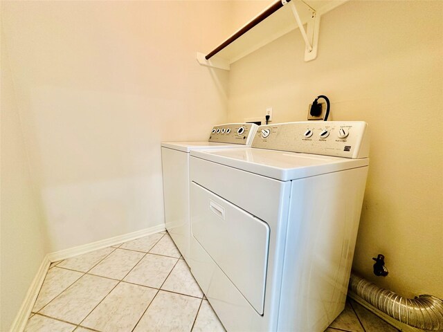 4142 Surreydon Dr, Houston, TX 77014 - laundry area featuring separate washer and dryer, baseboards, and light tile patterned floors