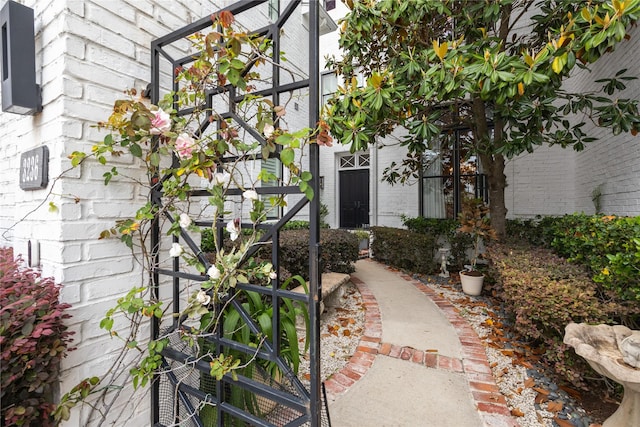 doorway to property with brick siding