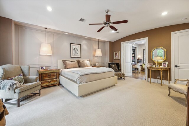bedroom with light carpet, a decorative wall, recessed lighting, vaulted ceiling, and ceiling fan