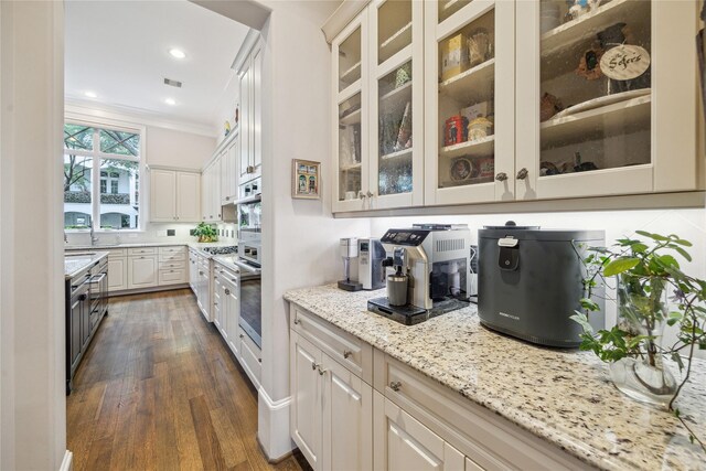 bar area with oven, dark wood-style flooring, crown molding, and recessed lighting