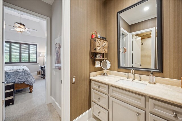 bathroom with ceiling fan, vanity, baseboards, wallpapered walls, and connected bathroom