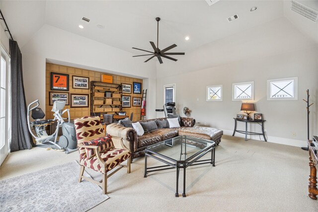 living area featuring light carpet, a ceiling fan, recessed lighting, baseboards, and high vaulted ceiling