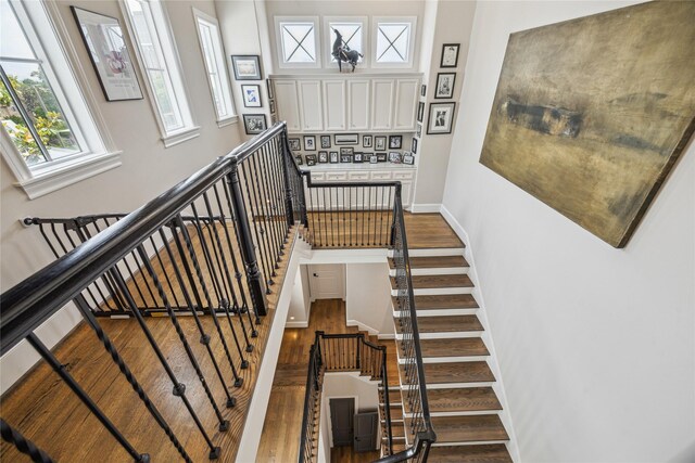 stairway featuring wood finished floors and baseboards