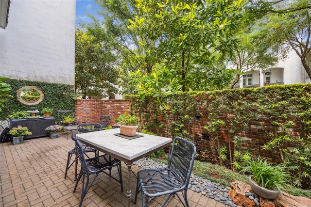 view of patio with outdoor dining space and fence