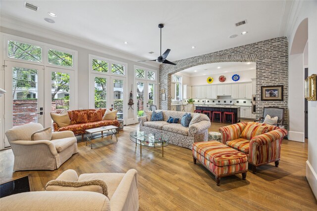 living room with ornamental molding, french doors, a ceiling fan, plenty of natural light, and recessed lighting