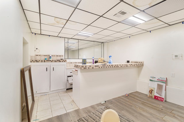 laundry room featuring light wood-style flooring