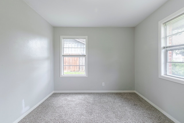 unfurnished room with plenty of natural light, carpet floors, and baseboards