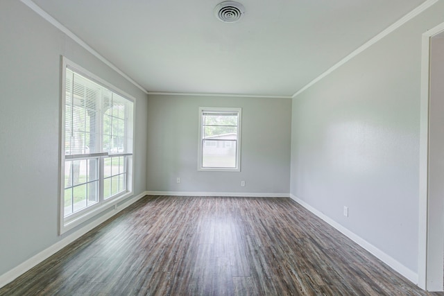 spare room with dark wood-style flooring, ornamental molding, and baseboards
