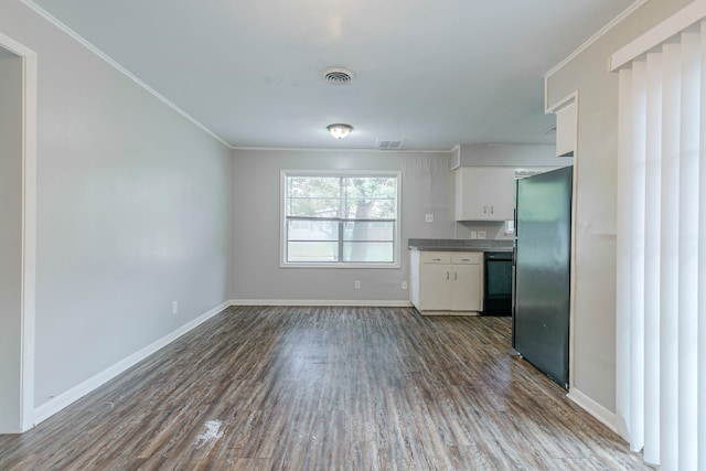 kitchen with freestanding refrigerator, black dishwasher, dark wood-style flooring, crown molding, and white cabinetry