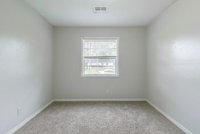 carpeted spare room with baseboards