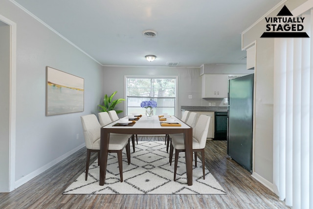 7150 Edgemoor Dr, Houston, TX 77074 - dining room with wood finished floors, baseboards, and crown molding