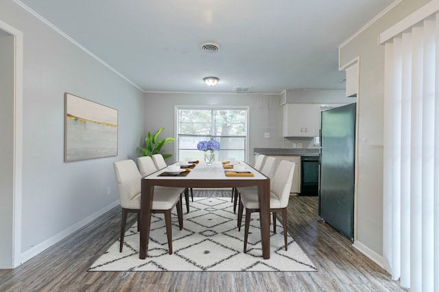 7150 Edgemoor Dr, Houston, TX 77074 - dining room with wood finished floors, crown molding, and baseboards