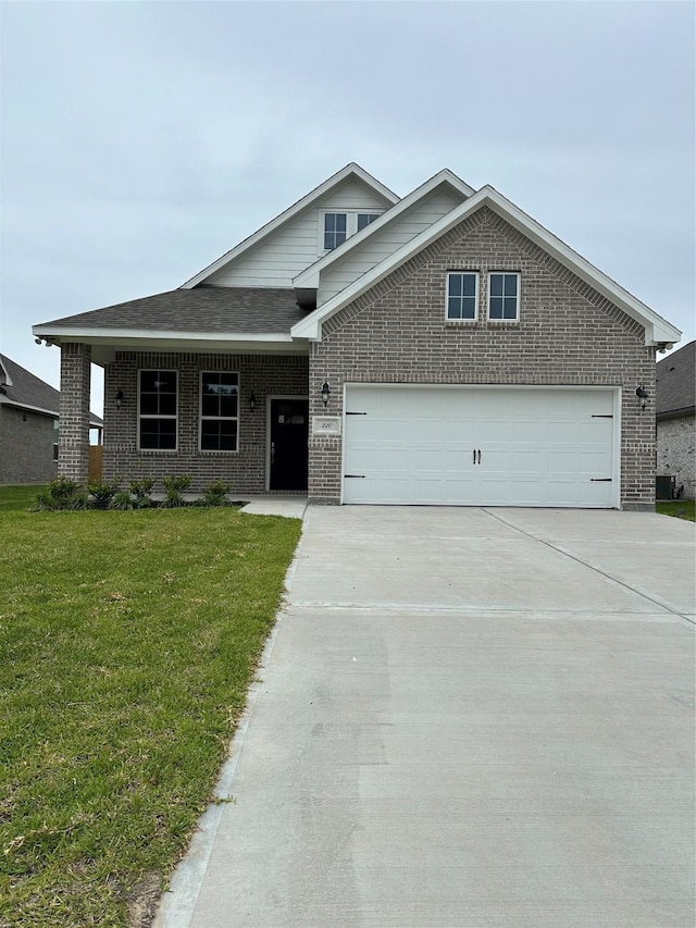 traditional home with driveway, brick siding, a front lawn, and a garage