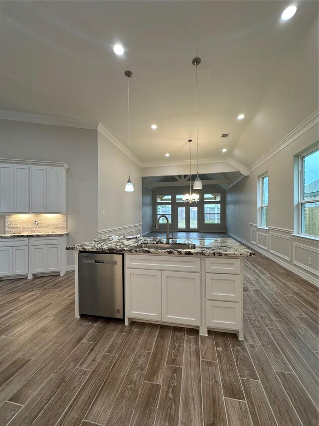 kitchen with a sink, stainless steel dishwasher, dark wood-type flooring, white cabinetry, and healthy amount of natural light