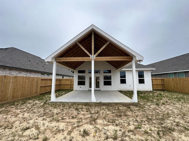 rear view of property featuring a patio and a fenced backyard