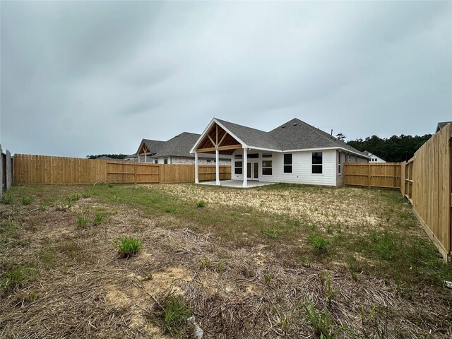 rear view of property with a patio area and a fenced backyard