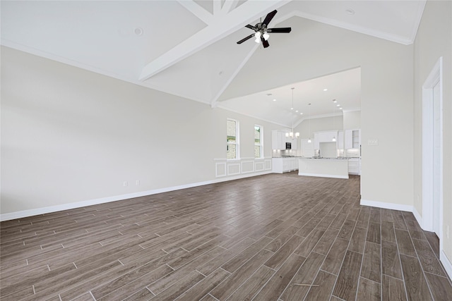 310 Little Spring Ct, Anahuac, TX 77514 - unfurnished living room with beamed ceiling, dark wood-type flooring, high vaulted ceiling, a ceiling fan, and baseboards
