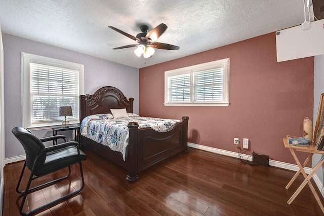 bedroom featuring baseboards, dark wood-style flooring, a textured ceiling, and a ceiling fan