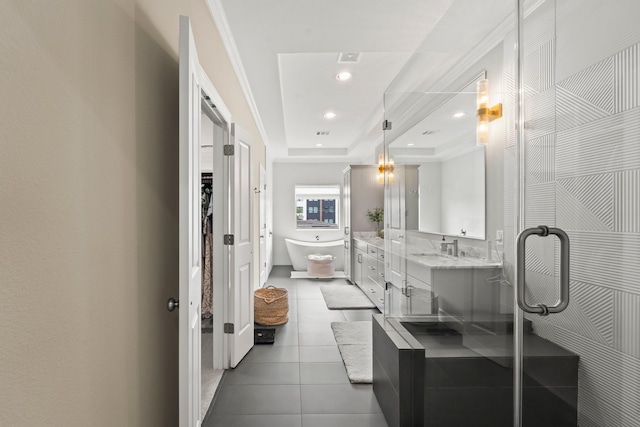 full bathroom with a raised ceiling, a soaking tub, tile patterned floors, double vanity, and recessed lighting
