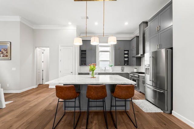 118 Reinerman St, Houston, TX 77007 - kitchen with premium appliances, wall chimney exhaust hood, ornamental molding, baseboards, and light stone countertops