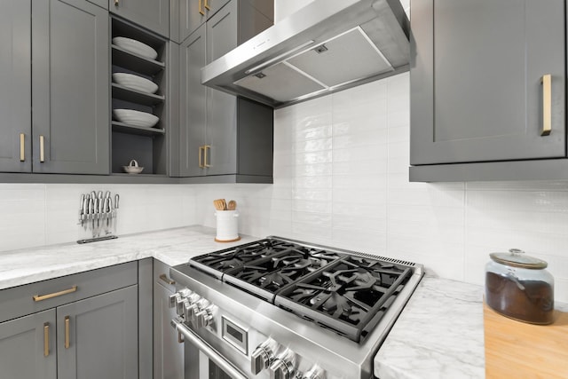 kitchen featuring extractor fan, range with two ovens, gray cabinets, backsplash, and open shelves