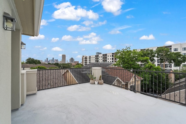 view of patio featuring a skyline view and a balcony