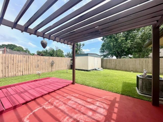 view of patio featuring a storage shed, an outbuilding, a deck, and a pergola