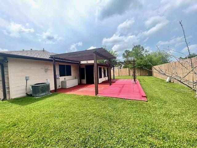 rear view of property with a pergola, central AC unit, and a wooden deck