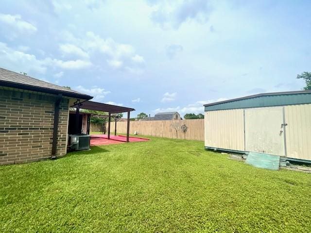 view of yard with a patio area, an outbuilding, and cooling unit