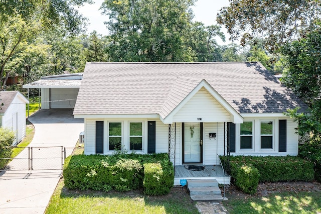111 S Roosevelt Ave, Cleveland, TX 77327 - view of front of home with covered porch, a gate, roof with shingles, and fence
