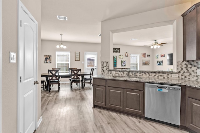 14108 Kamilia Rd, Conroe, TX 77306 - kitchen featuring stainless steel dishwasher, dark brown cabinets, light wood-type flooring, decorative backsplash, and a sink