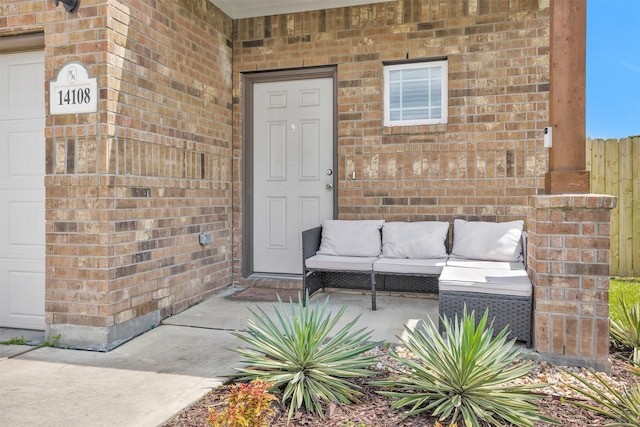 14108 Kamilia Rd, Conroe, TX 77306 - view of exterior entry featuring brick siding and outdoor lounge area