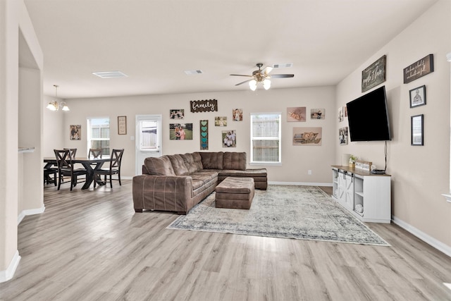 14108 Kamilia Rd, Conroe, TX 77306 - living area with wood finished floors, plenty of natural light, and baseboards