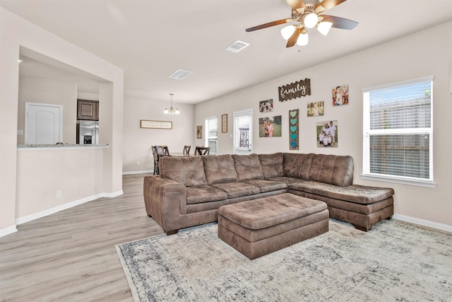 14108 Kamilia Rd, Conroe, TX 77306 - living area with light wood-style floors, baseboards, a chandelier, and a ceiling fan