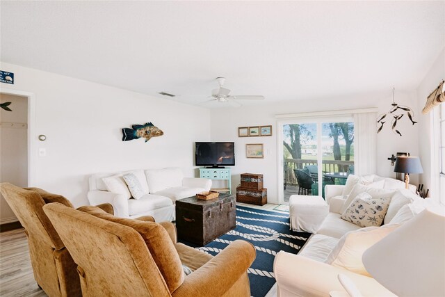 living room with a ceiling fan and wood finished floors