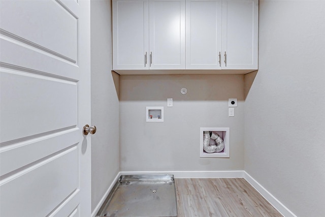 8119 Blue Fish Dr, Cypress, TX 77433 - laundry room with hookup for an electric dryer, washer hookup, baseboards, light wood-style flooring, and cabinet space