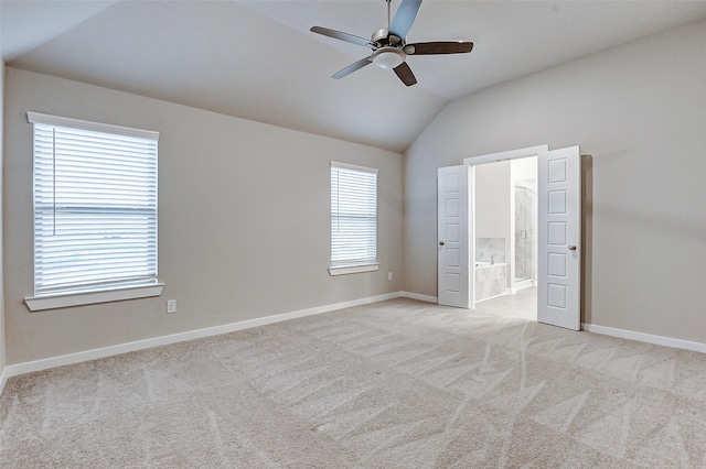 8119 Blue Fish Dr, Cypress, TX 77433 - unfurnished bedroom featuring vaulted ceiling, light carpet, baseboards, ensuite bathroom, and ceiling fan