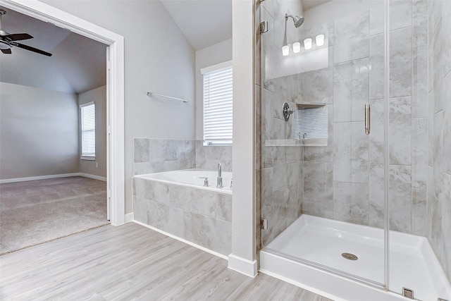 8119 Blue Fish Dr, Cypress, TX 77433 - bathroom with a shower stall, a ceiling fan, lofted ceiling, a bath, and wood finished floors