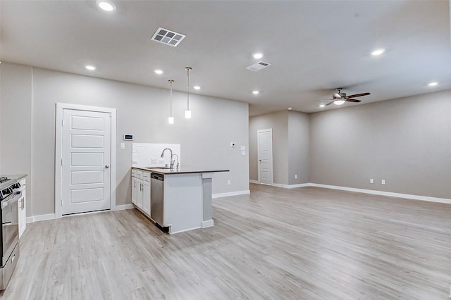8119 Blue Fish Dr, Cypress, TX 77433 - kitchen featuring appliances with stainless steel finishes, ceiling fan, a peninsula, recessed lighting, and a sink