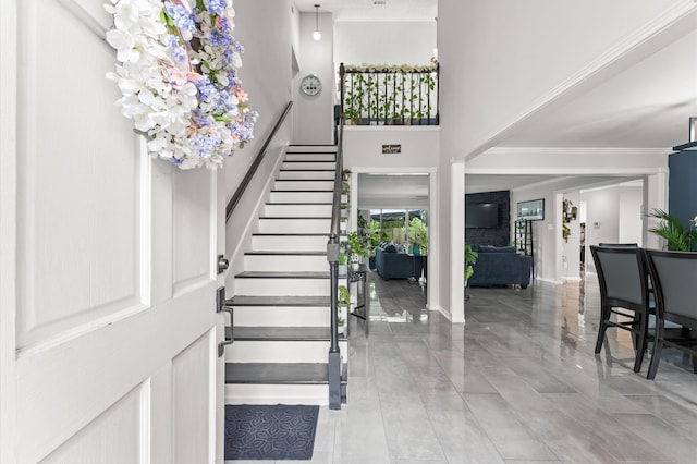 16603 April Hill St, Houston, TX 77095 - foyer entrance featuring stairway, crown molding, a towering ceiling, baseboards, and marble finish flooring