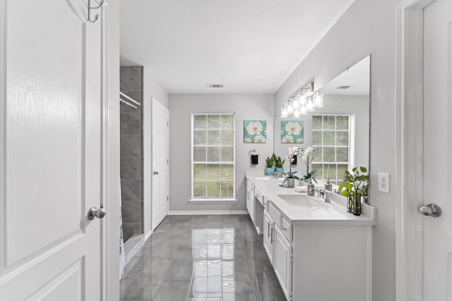 16603 April Hill St, Houston, TX 77095 - full bath featuring double vanity, baseboards, and a tile shower