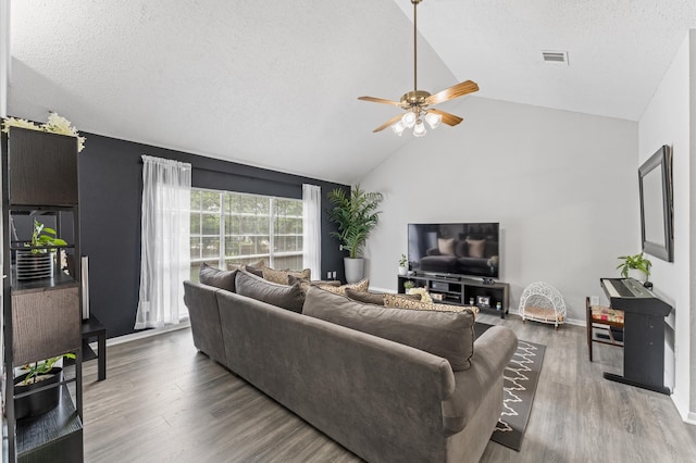 16603 April Hill St, Houston, TX 77095 - living area with ceiling fan, wood finished floors, a textured ceiling, baseboards, and high vaulted ceiling